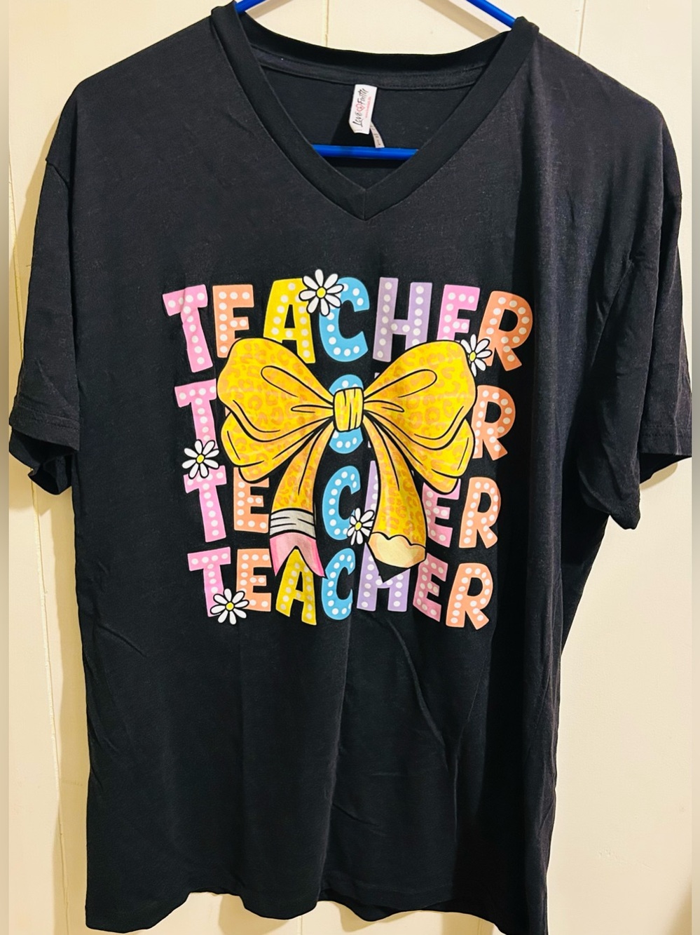 Women’s Love in Faith Large Black V-Neck Shirt With “Teacher” & A Bow